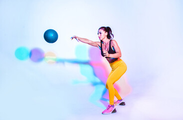 Woman training with the exercizes ball in the gym