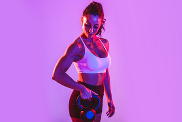 Woman training with dumbbells in the gym