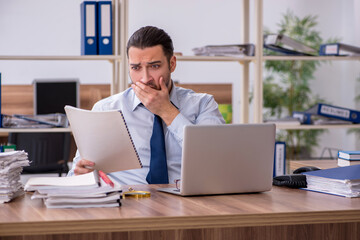 Young male employee unhappy with excessive work