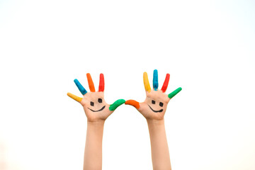 Children hand in colorful paint with smile isolated on white