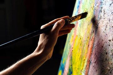 Somebody is painting some picture with paintbrush, isolated on black background