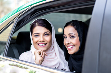 Fototapeta premium Two arabian girls spending time togehter outdoor making activities