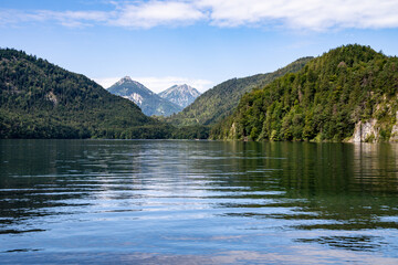 Quiet mountain lake with blue sky and clouds