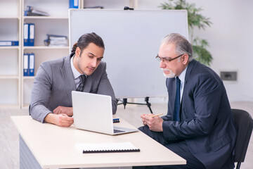 Fototapeta premium Old and young businessmen in business meeting concept