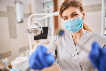 Dentist holding dental tools in a laboratory