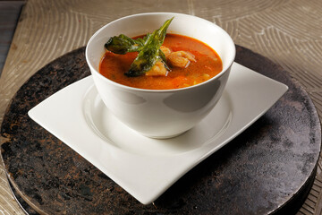 Shrimp broth and fish fillet with vegetables.