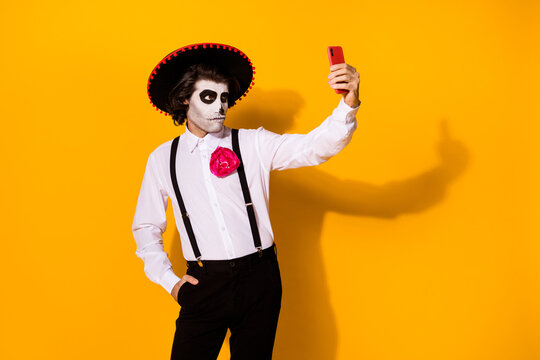 Portrait of his he nice painted creepy serious imposing guy caballero boyfriend taking making selfie calavera catrina look outfit isolated bright vivid shine vibrant yellow color background