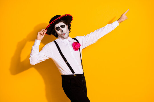 Profile photo of scary charismatic guy spanish tradition dance hold cap direct finger empty space wear white shirt rose death costume sombrero suspenders isolated yellow color background