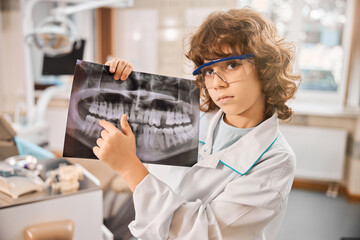 Little boy is standing in dental clinic