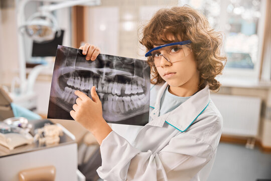 Little boy is standing in dental clinic
