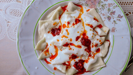 Traditional Turkish cuisine Ravioli, Manti Manlama serving with yogurt and fried butter sauce. 