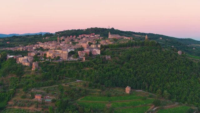 Aerial footage of medieval city Montalcino,  illuminated by rising sun. Tuscany, Italy. Apple ProRes codec.