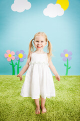 Obraz na płótnie Canvas Happy Little Girl Standing in Imaginary Outside Wonderland World