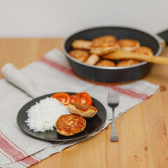 Plate with homemade salmon fish cutlets with rice on table