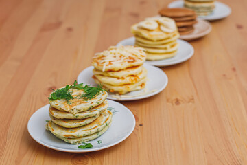 Stack of various pancakes on table, food background