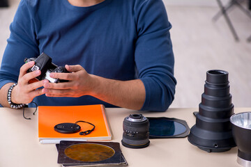 Young male photographer working in the studio