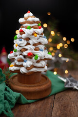 Baked gingerbread christmas tree on wooden background. Close-up