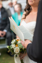 Obraz na płótnie Canvas close up of officiant vow book during wedding ceremony