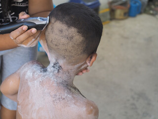 Boy cutting hair by thai stlye