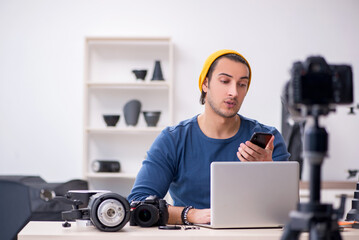 Young male photographer recording video for his blog