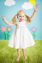 Happy Little Girl Jumping with Excitement in Imaginary Outside Wonderland World