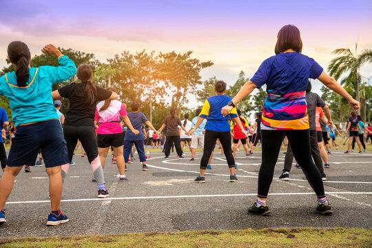 Group of people, woman  exercising with aerobics dancing in the garden.