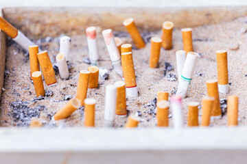 Many Cigarette butts discarded in ashtray