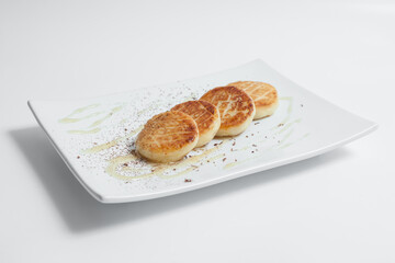 traditional russian cheesecakes with sour cream from cottage cheese isolated