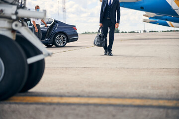 Well-dressed man coming back from a business trip