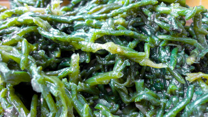 Close-up of fresh boiled sea beans. Turkish and Greek healthy Salicornia olive oil herb salad.