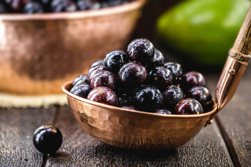 portion of jabuticabas in copper shell, typical fruit of Brazil, also called jaboticaba