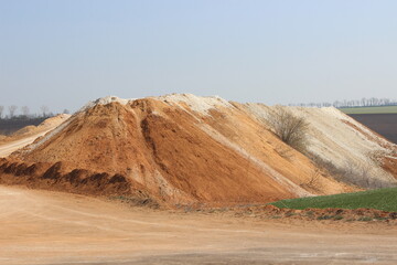 Clay mining. Waste soil hill and quarry road.
