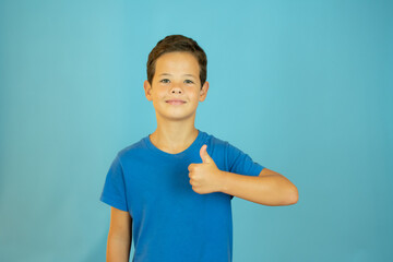 Handsome guy in blue shirt smiling with thumb up