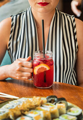 woman drinking mocktail in the cafe