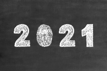 2021 bold numbers in handwritten chalk brush font, stock vector illustration clip art design element on grunge black chalkboard background for calendar, poster, flyer, card