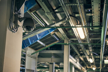 Fototapeta premium Security surveillance camera on a wall of a building
