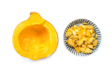 Orange pumpkin and pumpkin seeds on white background