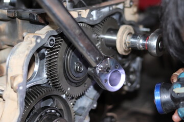 The mechanic is checking the engine.