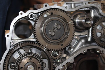 The mechanic is checking the engine.