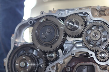 The mechanic is checking the engine.