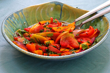Bowl of fresh peach, tomato and basil salad
