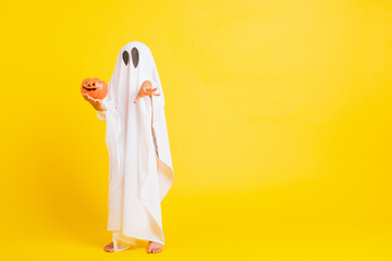 Funny Halloween Kid Concept, little cute child with white dressed costume halloween ghost scary he...