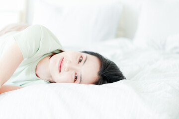 Fototapeta na wymiar Asian women laughing in bed