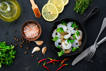 Top view of pan with raw prawn with spice and herbs