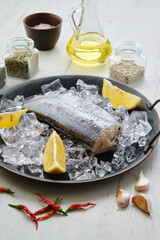 Raw pollock carcass on wooden background