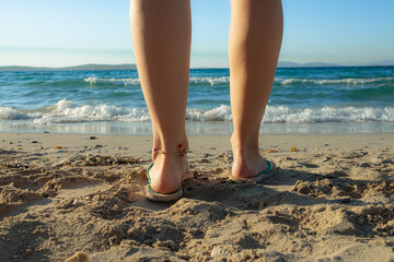 woman's beautiful legs on sand beach