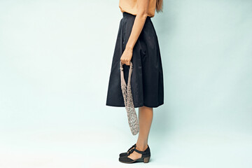 Girl with an empty shopping bag in her hands. Eco-bag in the hands of a girl. Eco-friendly packaging