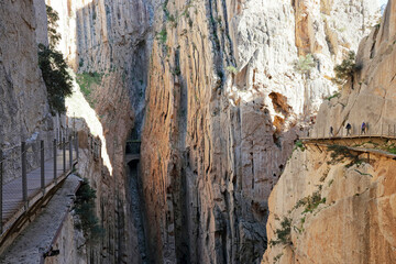 Hikers with helmets on the famous Caminito del Rey footpath near El Chorro, Andalucia, Spain