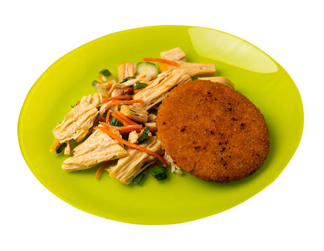 fishcake with soy asparagus and carrots, cucumbers and dilll. fish cutlet on a plate isolated. cutlet with vegetables top view
