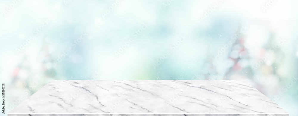 Aufkleber Perspective marble table with blur Christmas tree decorate string light and blue bokeh with snow light.Panoramic wooden countertop banner mock up for product display for online content